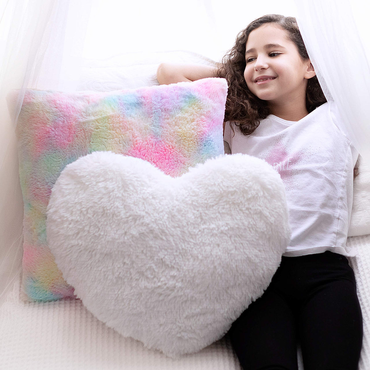 Perfectto Design white fluffy heart pillow adds cozy nursery decor and cuddle appeal.