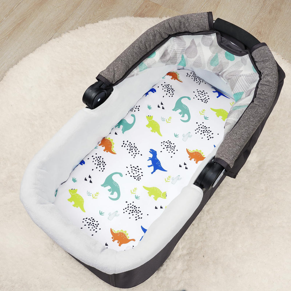 PHF dinosaur bassinet sheet care scene showing easy machine-wash fabric and quick-dry.