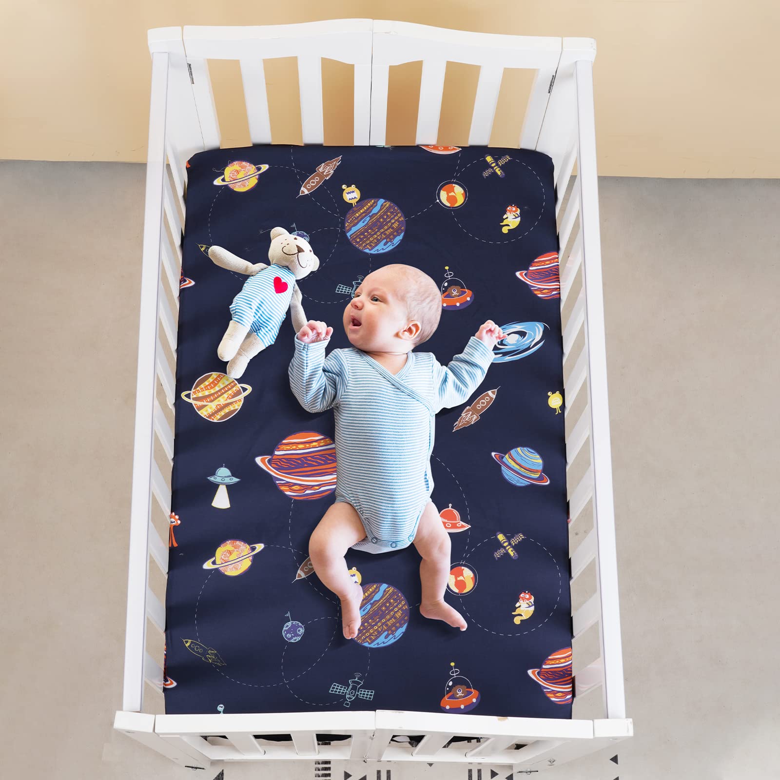 PHF universal-fit mini crib image demonstrates snug fit on 1-5 inch mattresses.