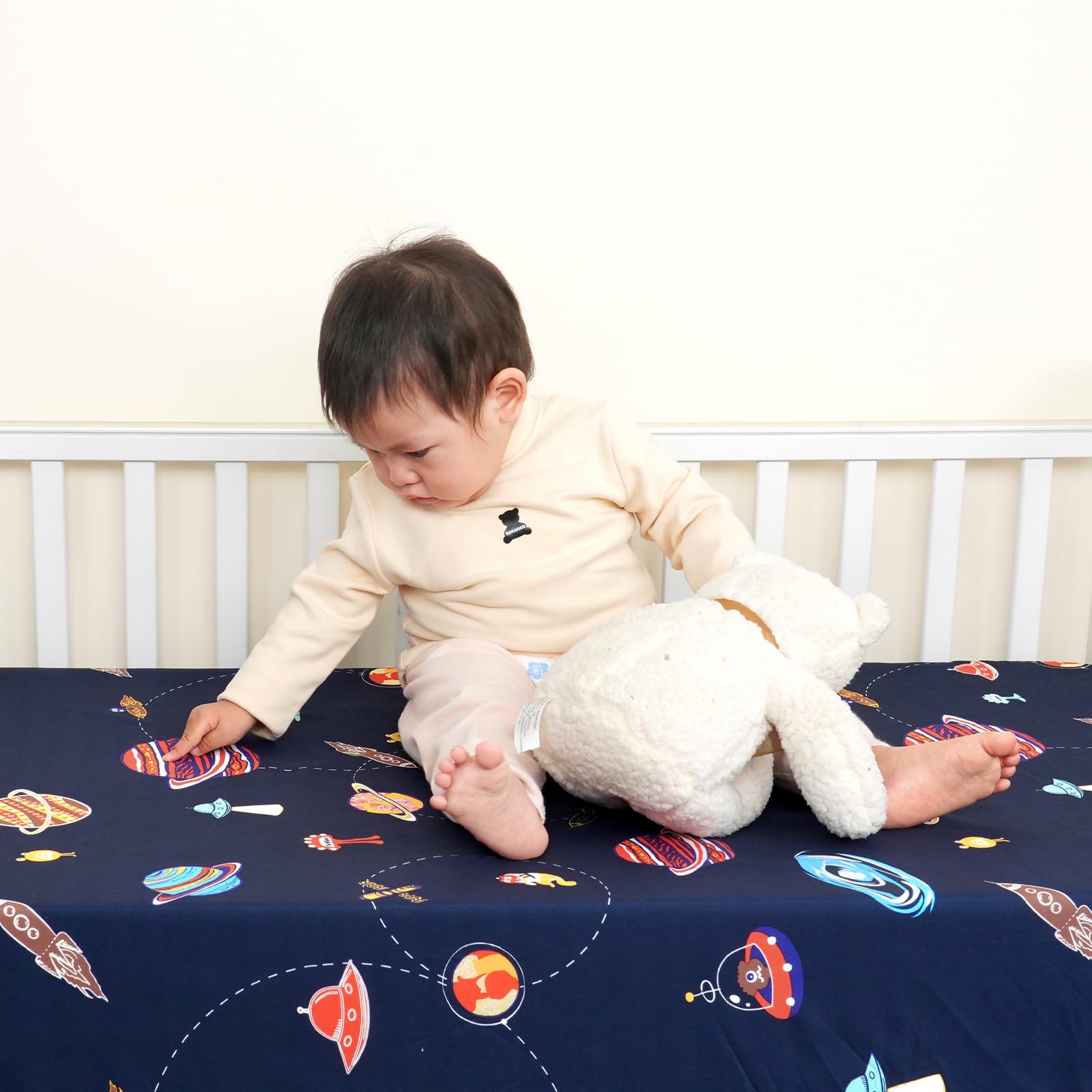 PHF Soft Space crib sheet fitted on a mattress demonstrates snug full-coverage elastic band