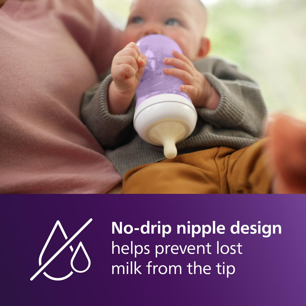 Ergonomic purple Philips Avent bottle in hand highlighting comfortable grip