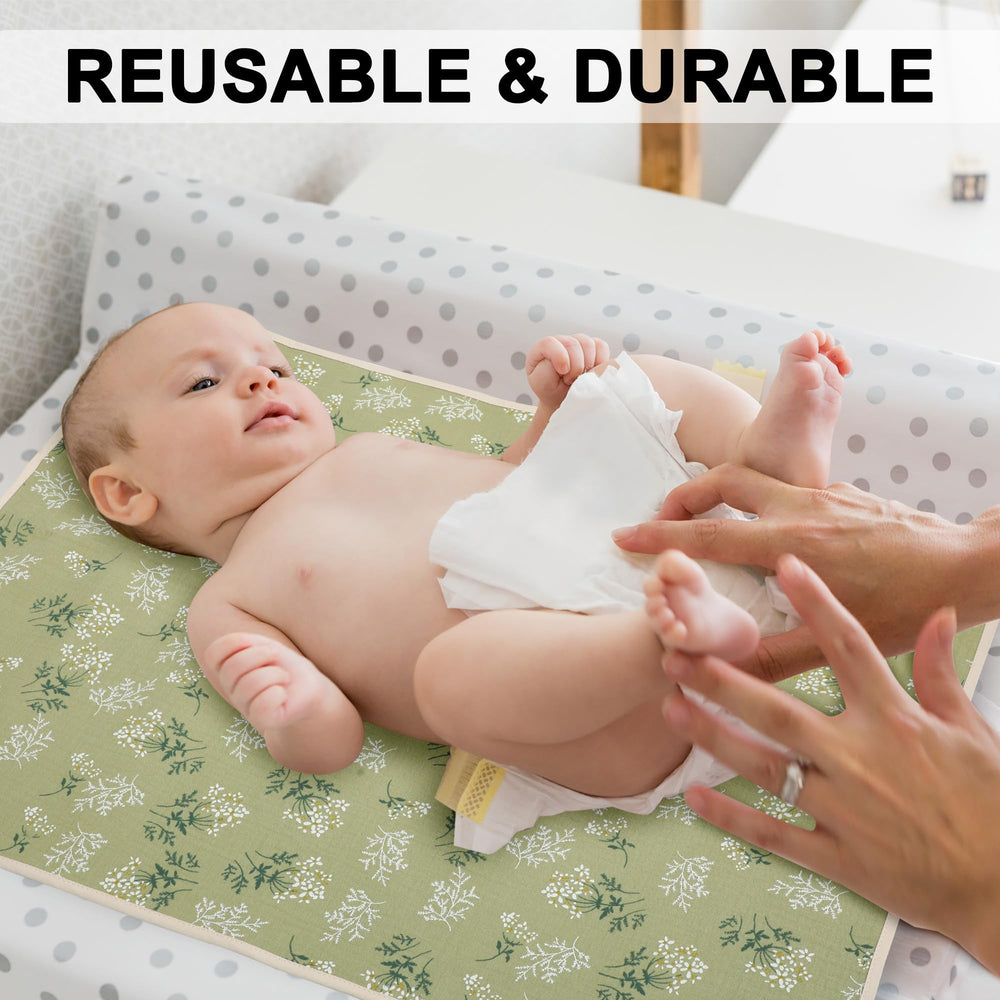 PHOEBUS BABY changing pad with muslin front panel for gentle skin contact during changes.