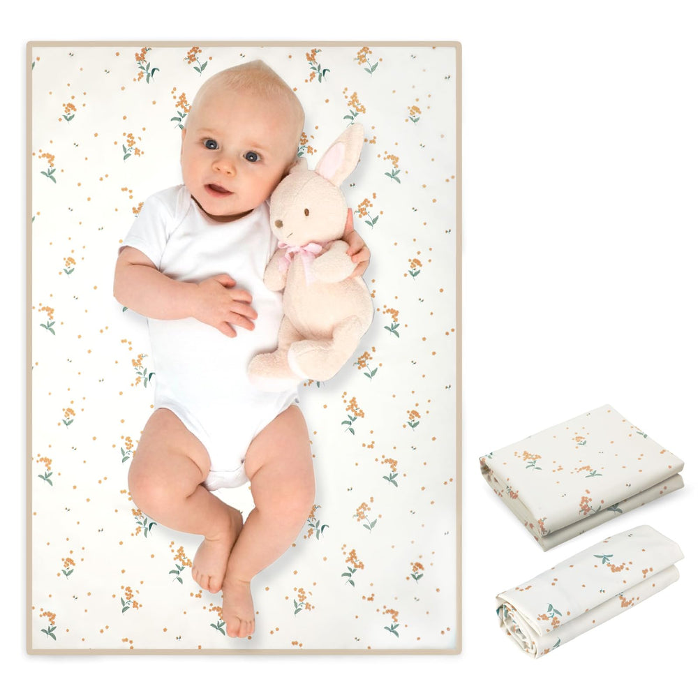 Phoebus Baby orange floral changing mat folded for travel convenience.