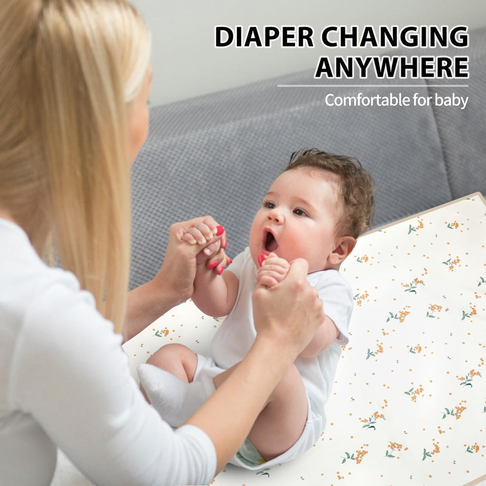 Phoebus Baby orange floral changing mat suitable for newborns and toddlers.