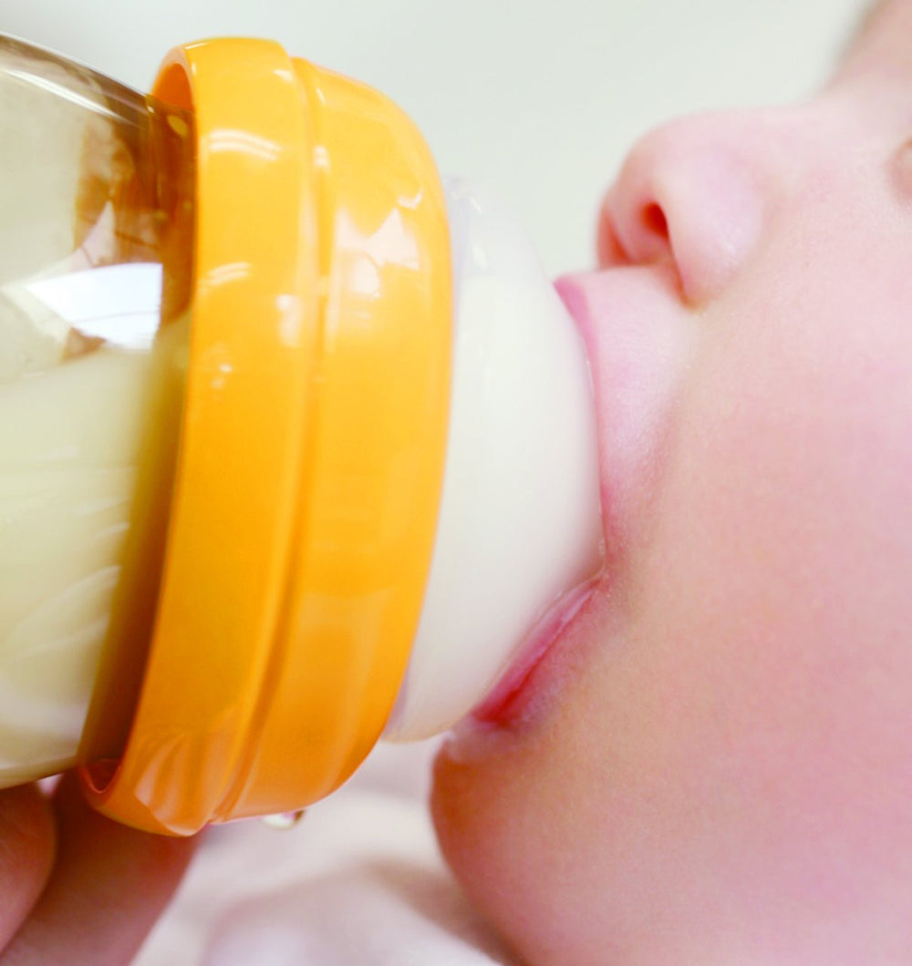 Pigeon nipple attached to bottle demonstrates realistic feeding setup
