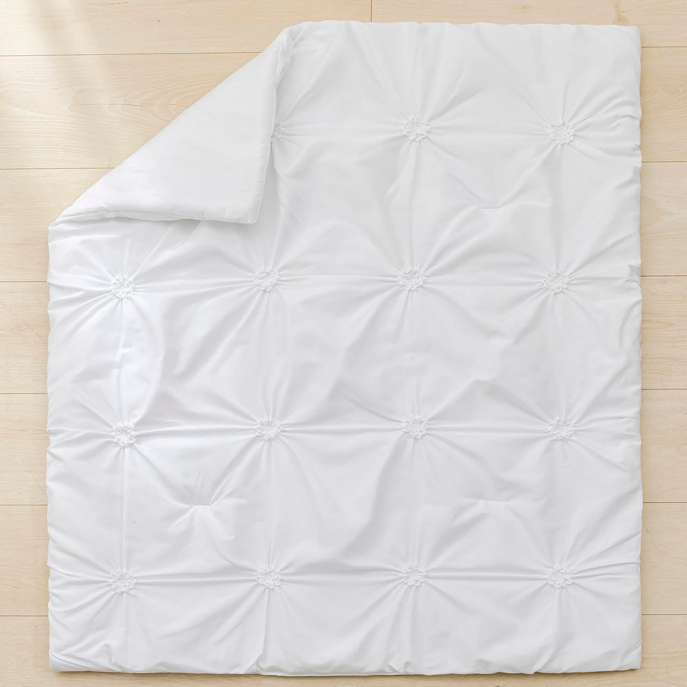PINNKKU 14-inch drop crib skirt demonstrates full coverage and hidden storage space.