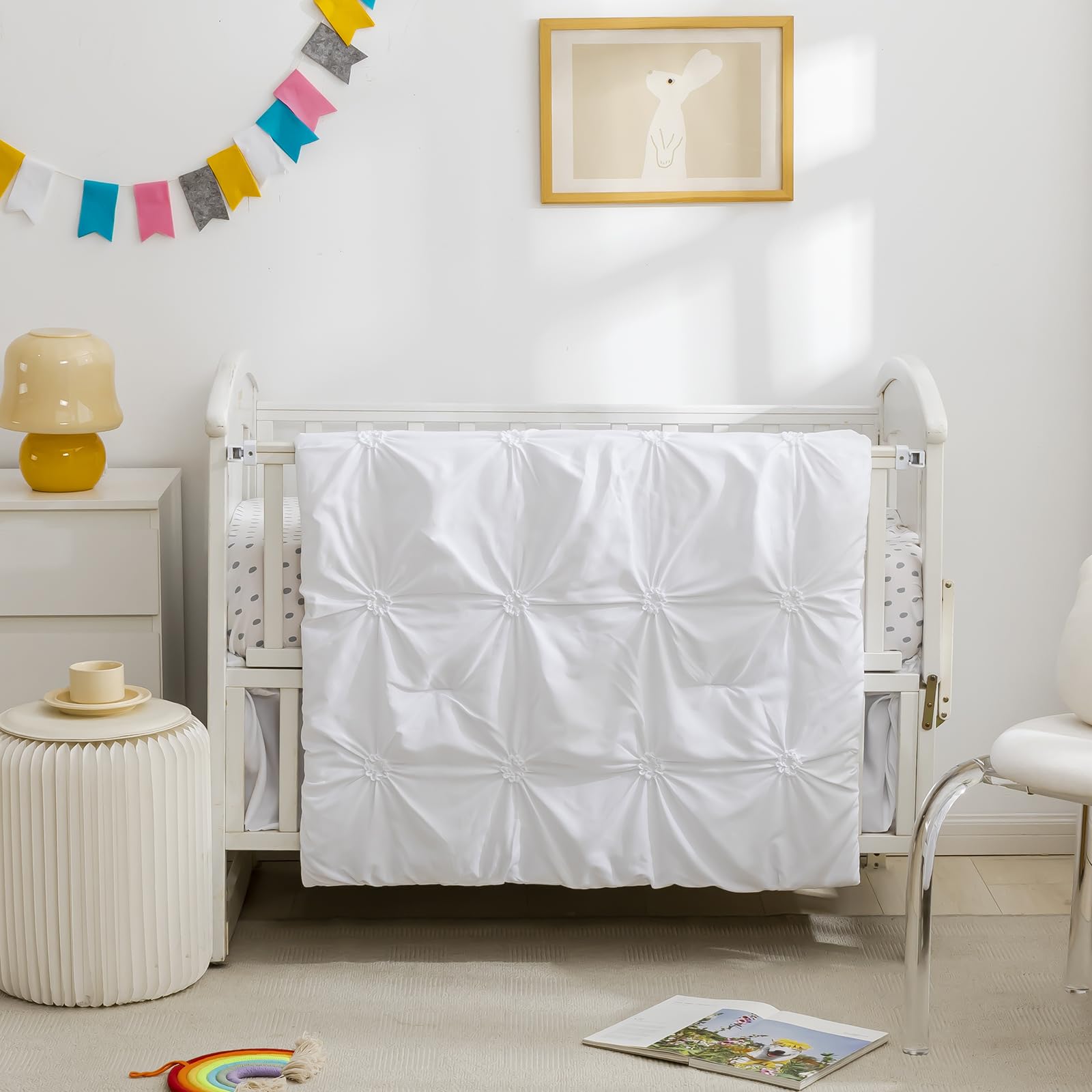 PINNKKU crib bedding set flatlay shows cohesive white pieces for a calm nursery.