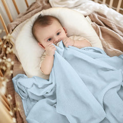 Pinuotu knitted baby blanket blue used as pram cover during walks.