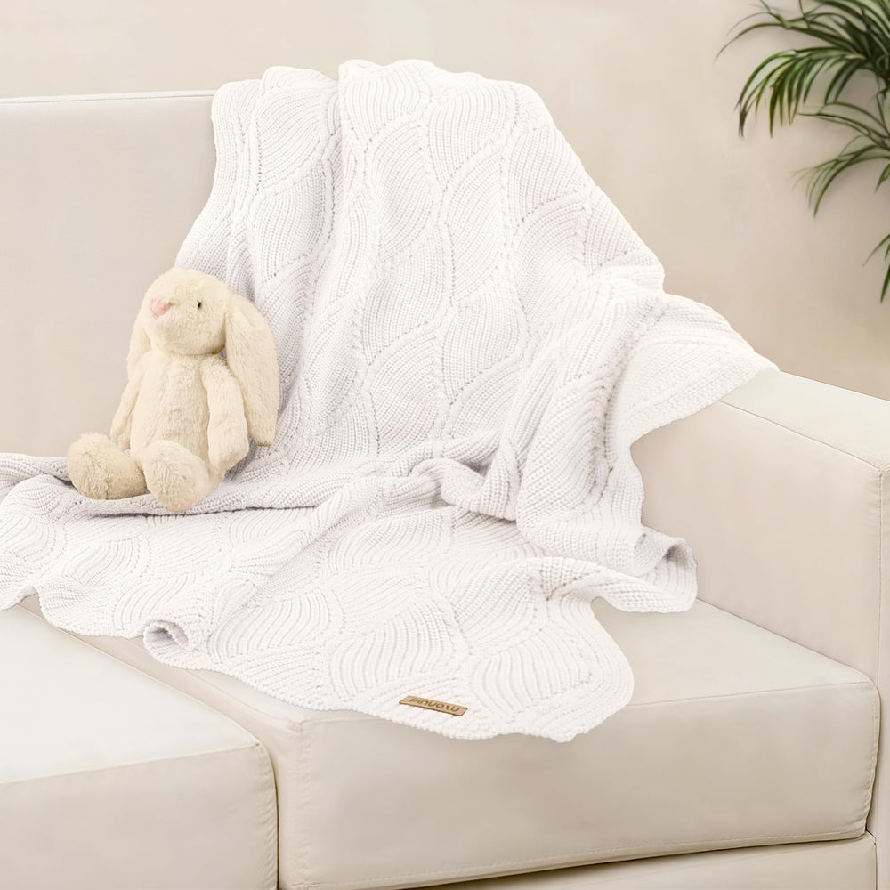 Pinuotu thick cotton knit blanket shown in nursery and stroller settings