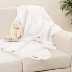 Pinuotu thick cotton knit blanket shown in nursery and stroller settings