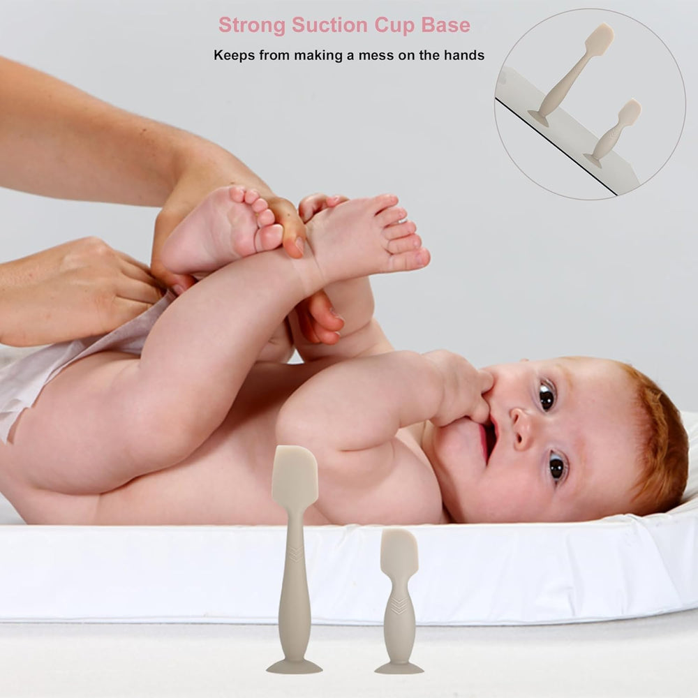 Pisool spatula with suction base fixed to a flat surface for hands-free use.