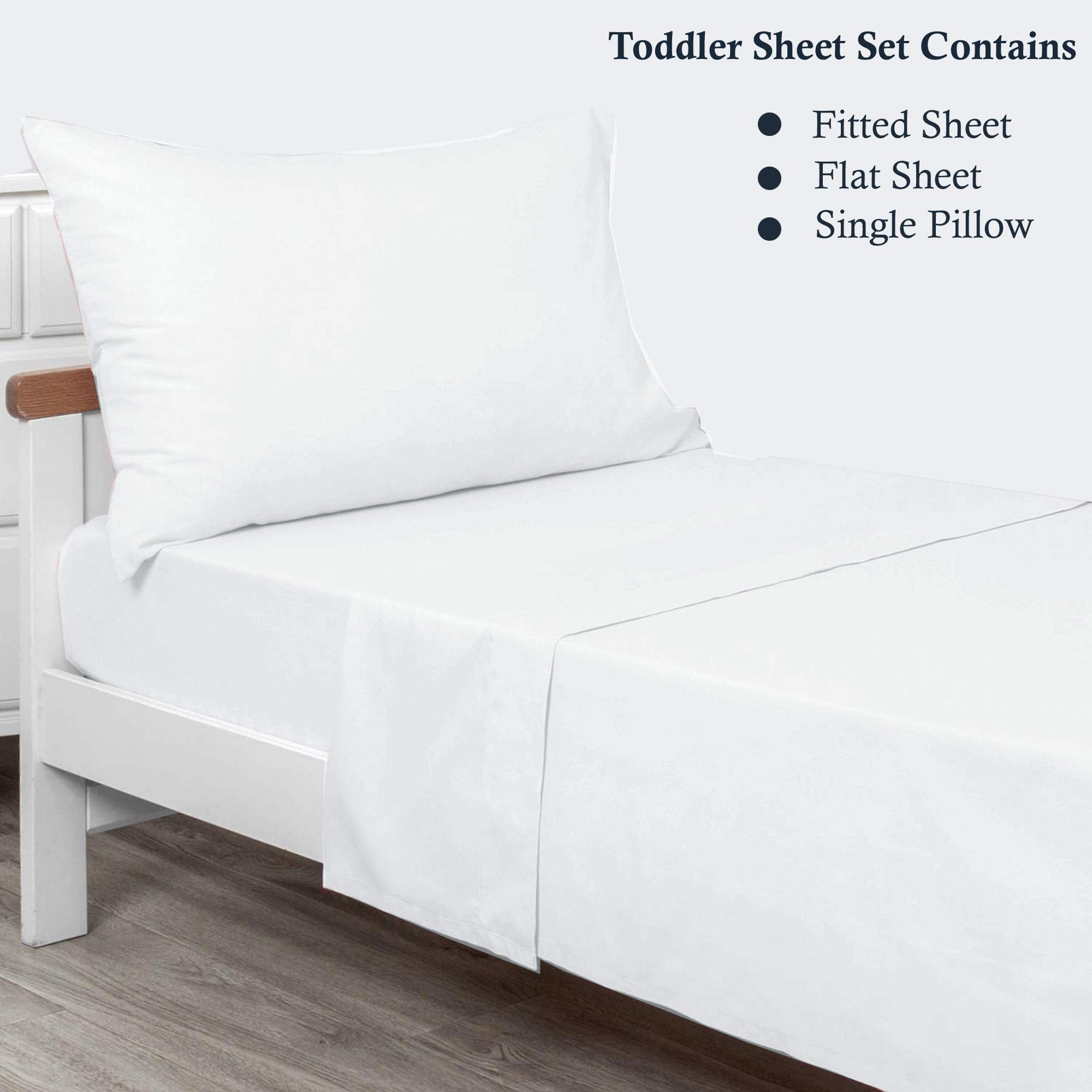 Plain Printed Linen toddler sheet set displayed on bed with neat, secure fit.