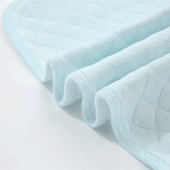 Pleasant Boulevard blue changing pad showing waterproof back for spills