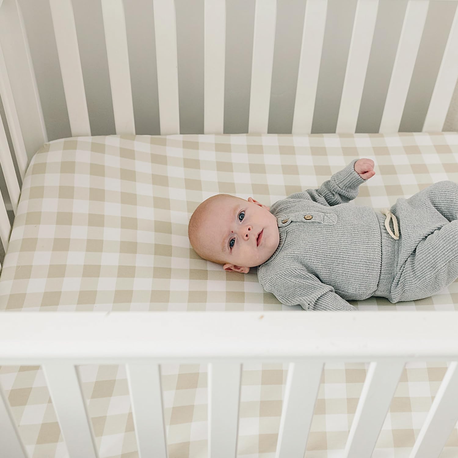 Pobibaby crib sheets pair with woodland nursery items for cohesive decor.