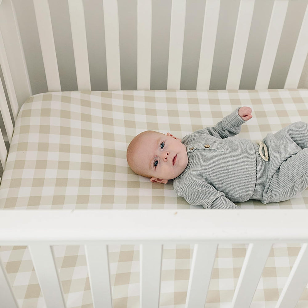Pobibaby crib sheets pair with woodland nursery items for cohesive decor.