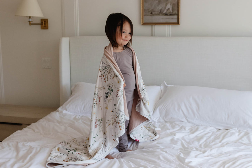 Pobibaby Wildflower blanket pairs with crib sheets for a cohesive nursery look.
