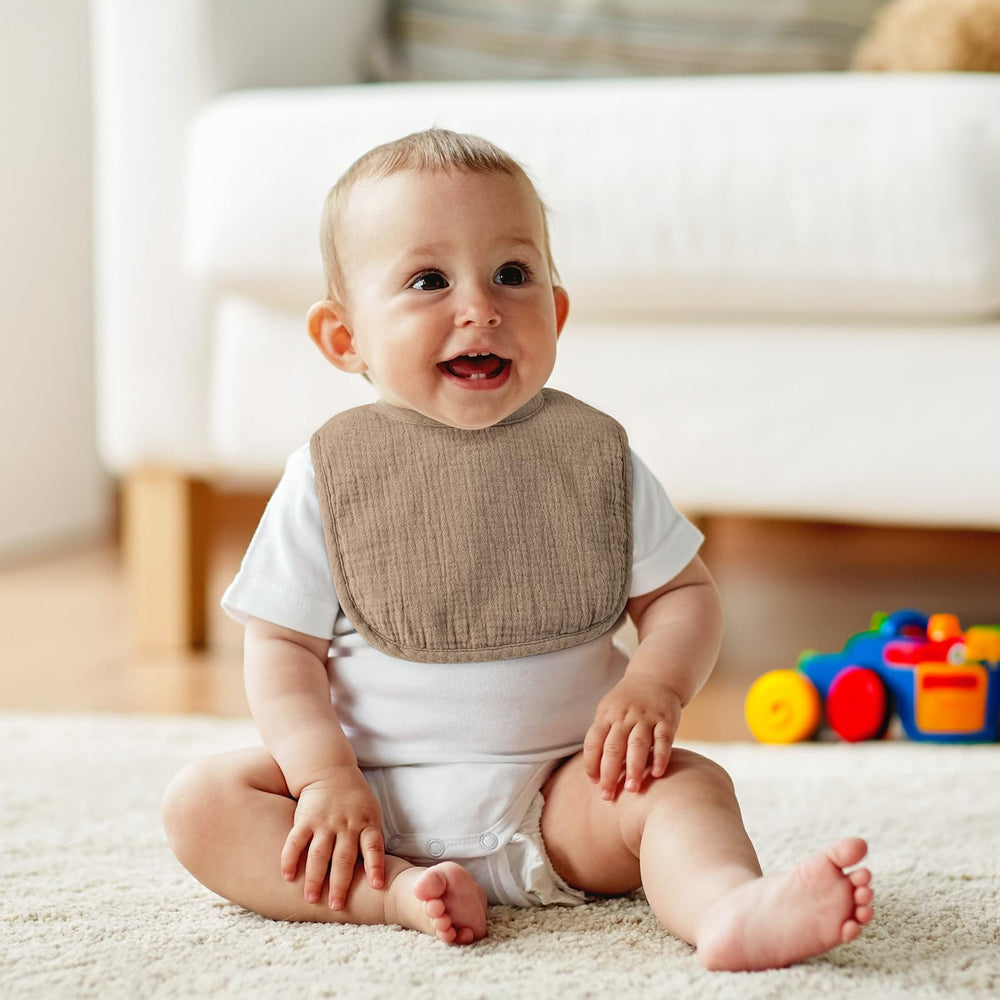 POIKSHARK Muslin Baby Bib on baby during feeding showing spill absorption.
