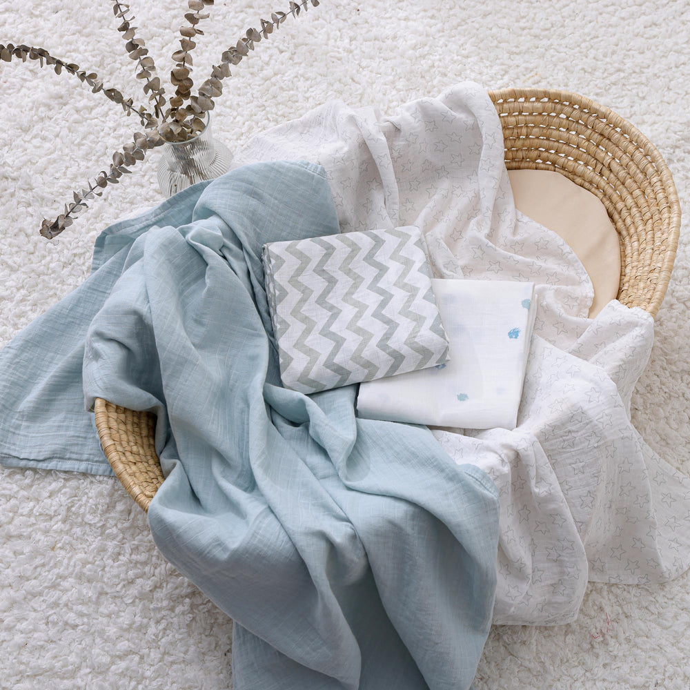 POMISO muslin swaddle used as baby prop in photography or nursery setup