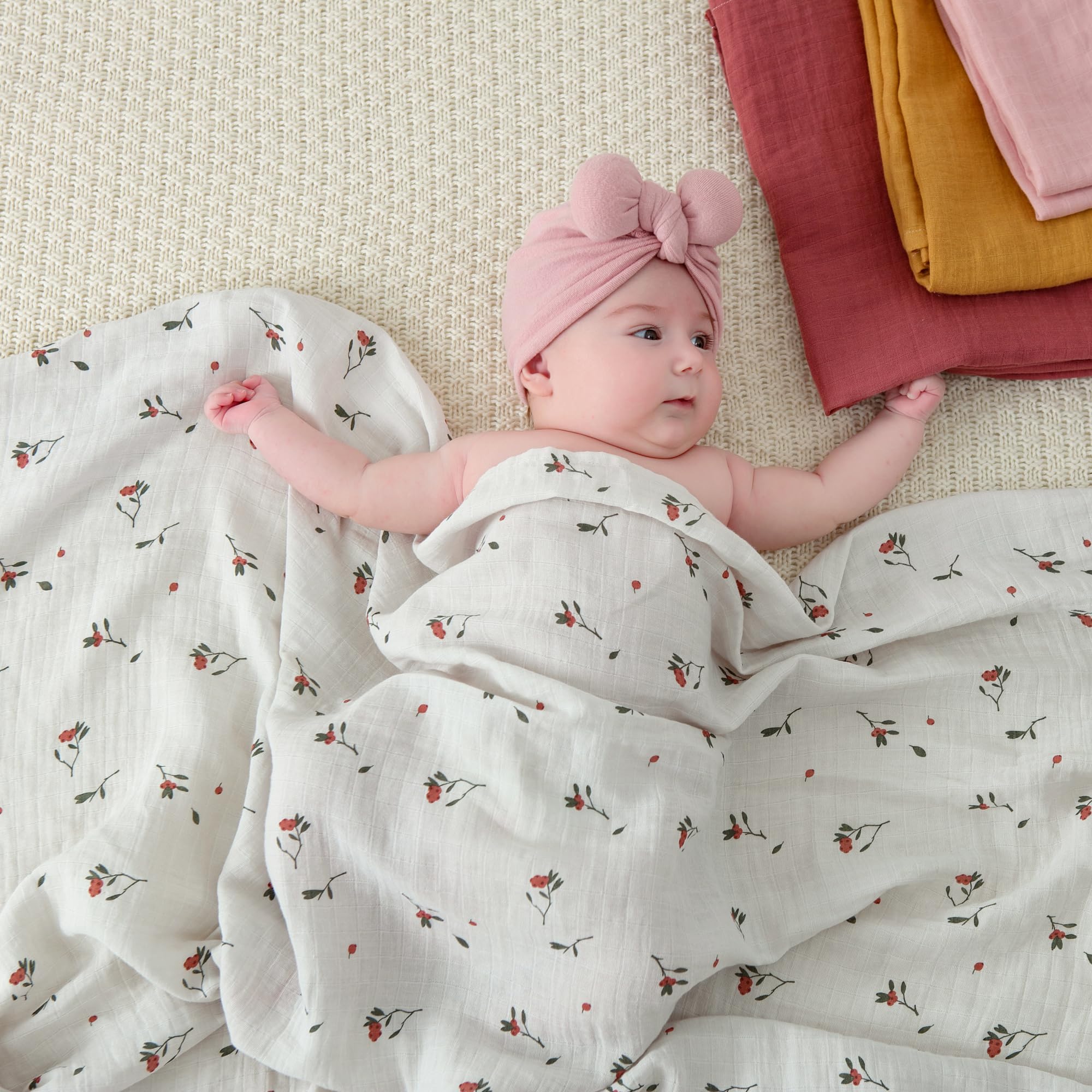 POMISO muslin swaddle blanket earthy colors flat lay for serene nursery aesthetics
