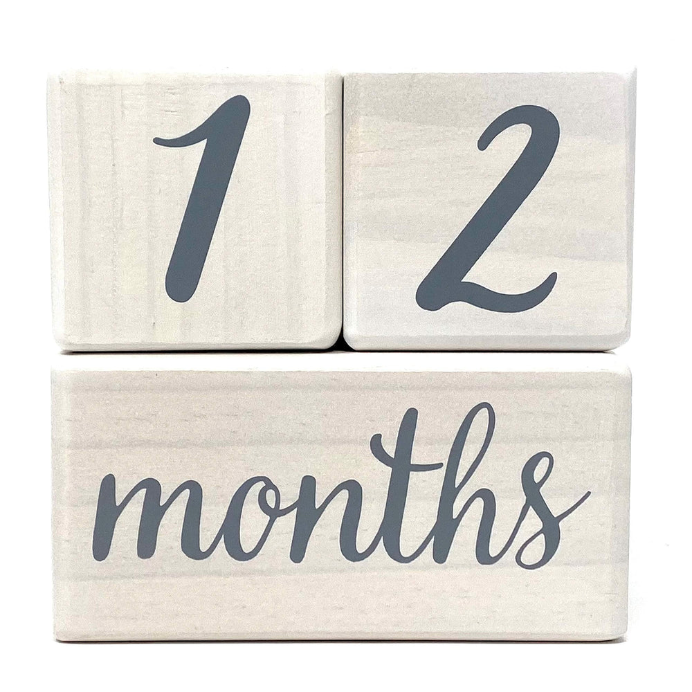 Pondering Pine milestone blocks with week labels arranged for weekly growth snapshots.