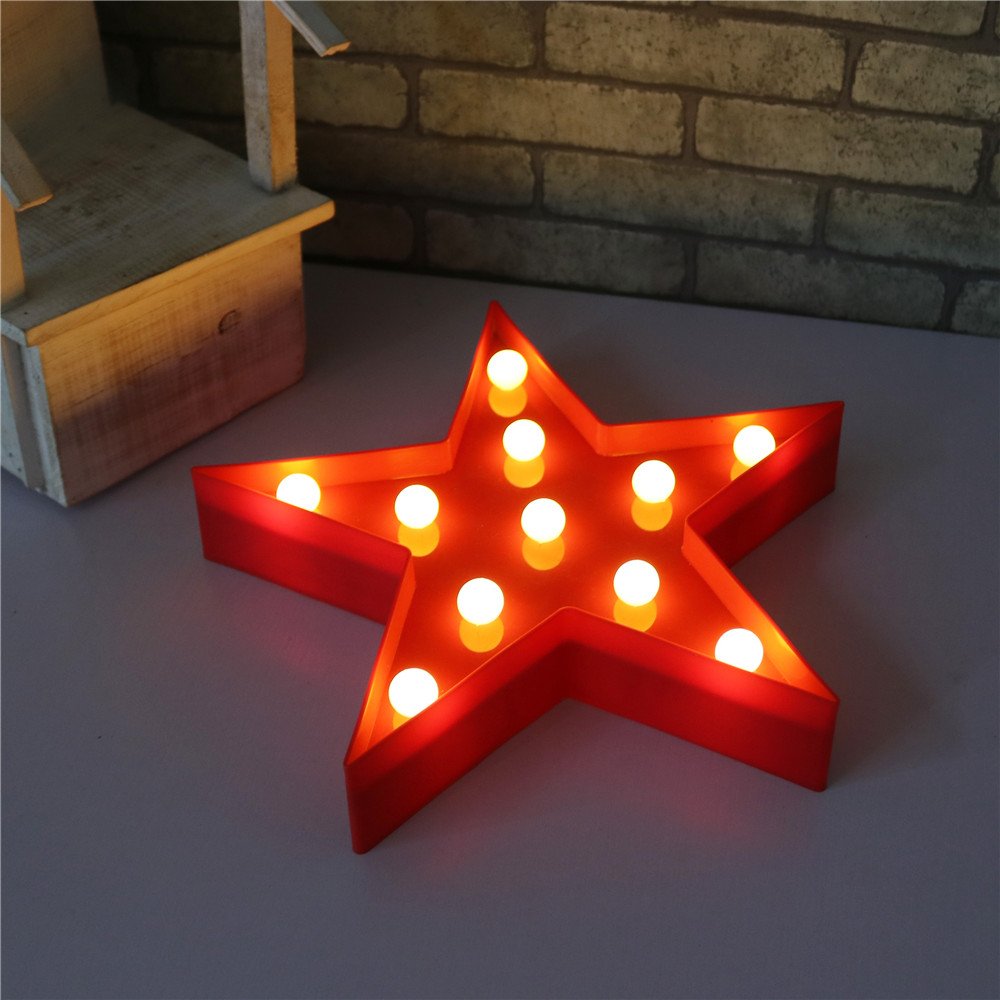 Pooqla Star Sign on mantel adds festive glow to living area.