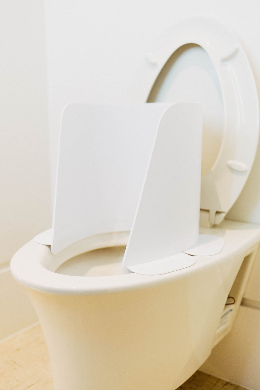 Potty Protector toilet shield protects against urine spray and bathroom splashes.