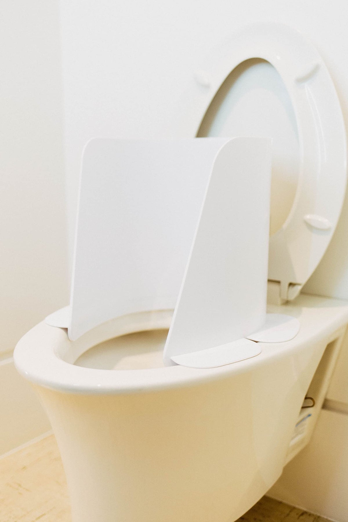 Potty Protector toilet shield protects against urine spray and bathroom splashes.