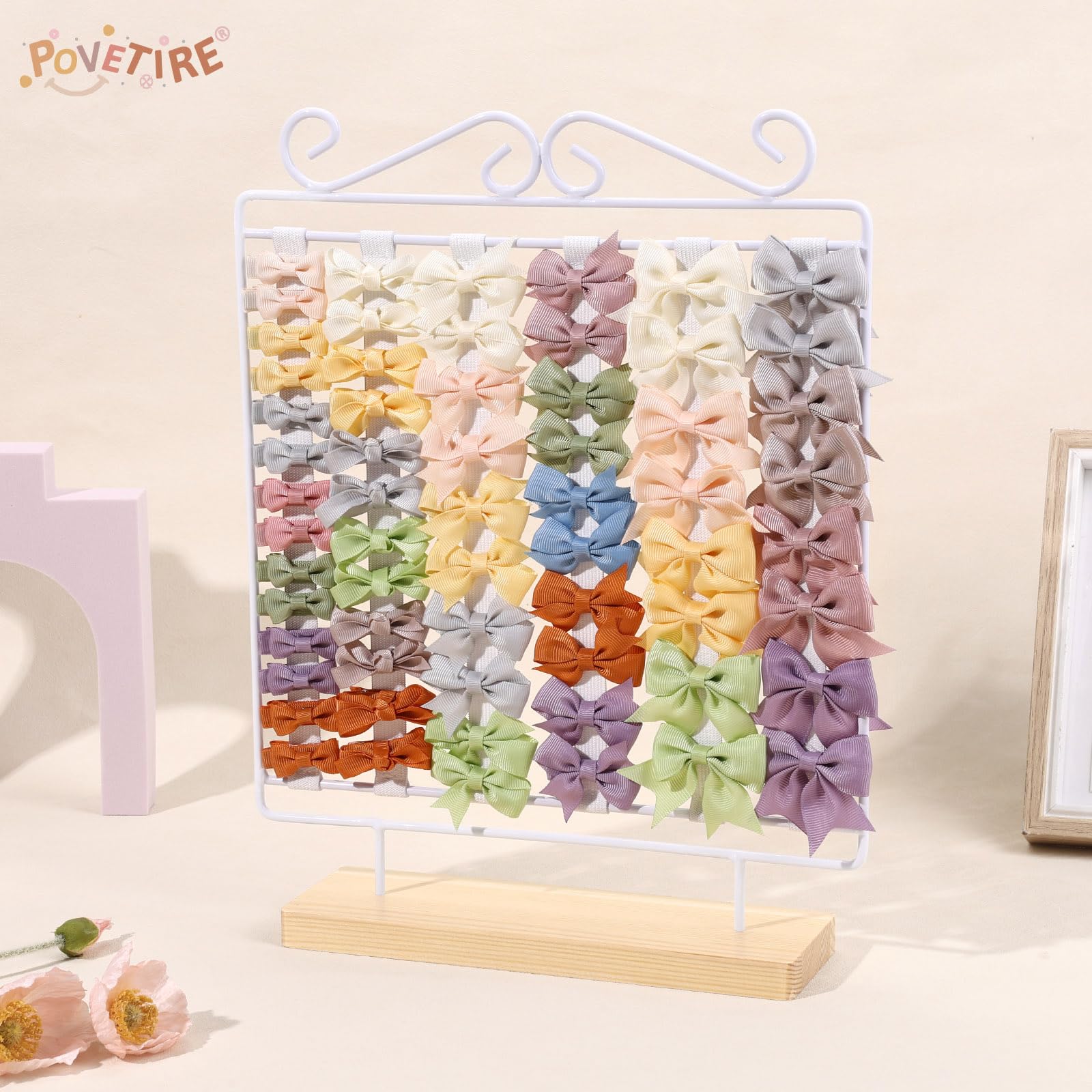 POVETIRE bow organizer featuring white iron stand for quick outfit prep.