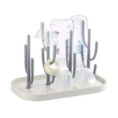Pujito baby bottle drying rack with tree-branch design dries bottles and teats.
