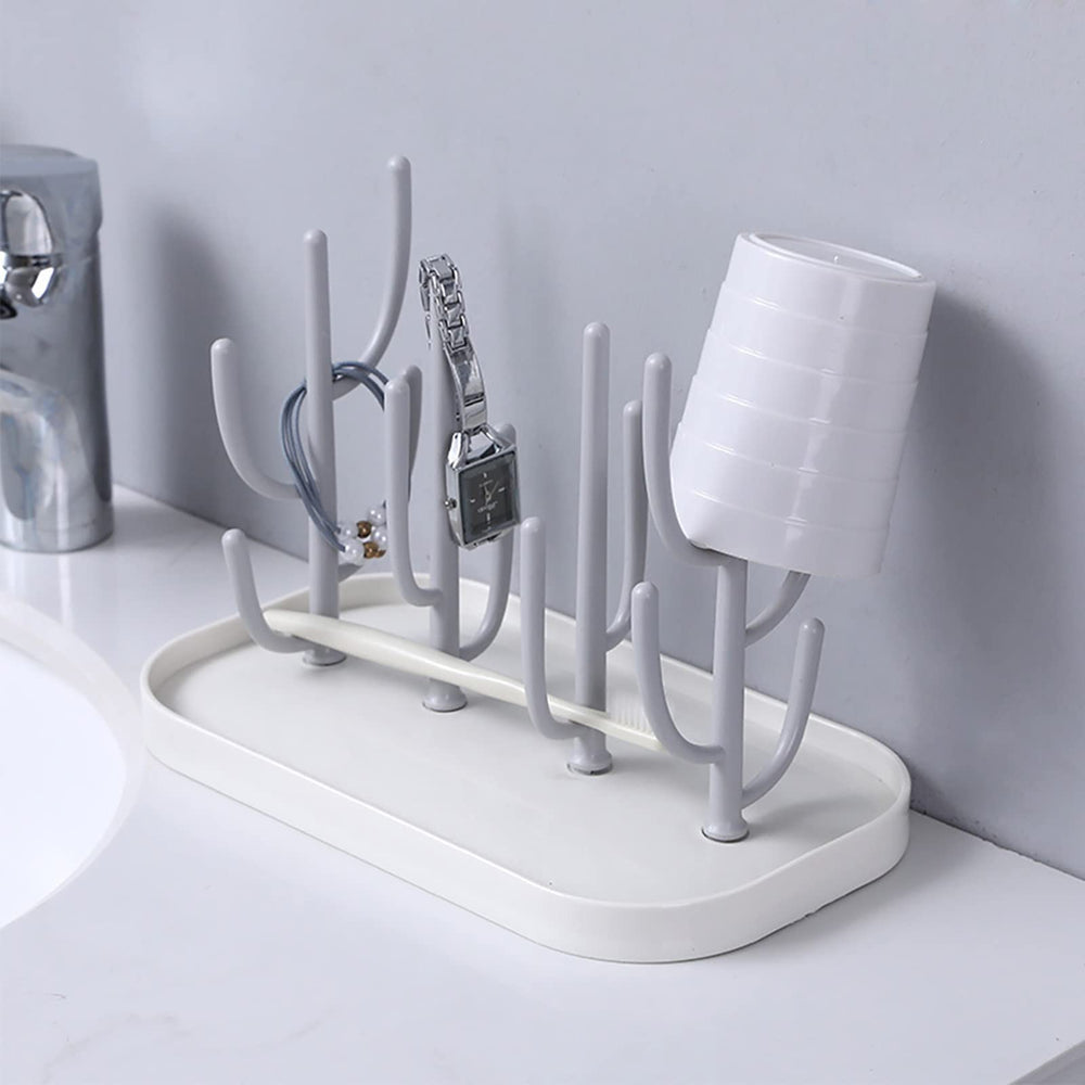 Pujito drying rack holds teats, cups, and pump parts for air-drying.
