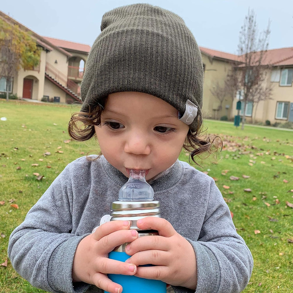 Pura Kiki Rose sippy cup in use with a child learning to sip.