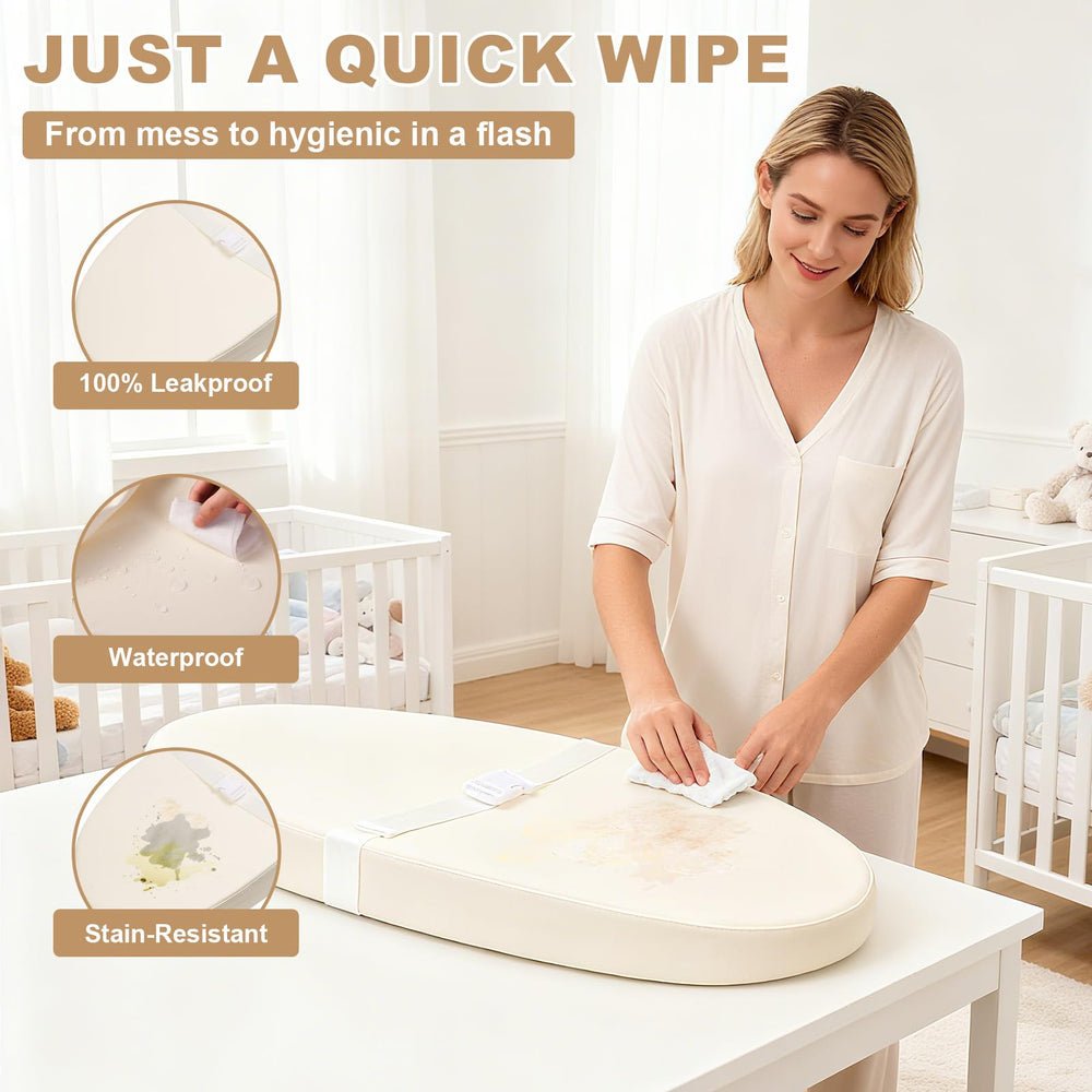 Qalvyn pad shows non-slip base and safety strap for secure diaper changes.