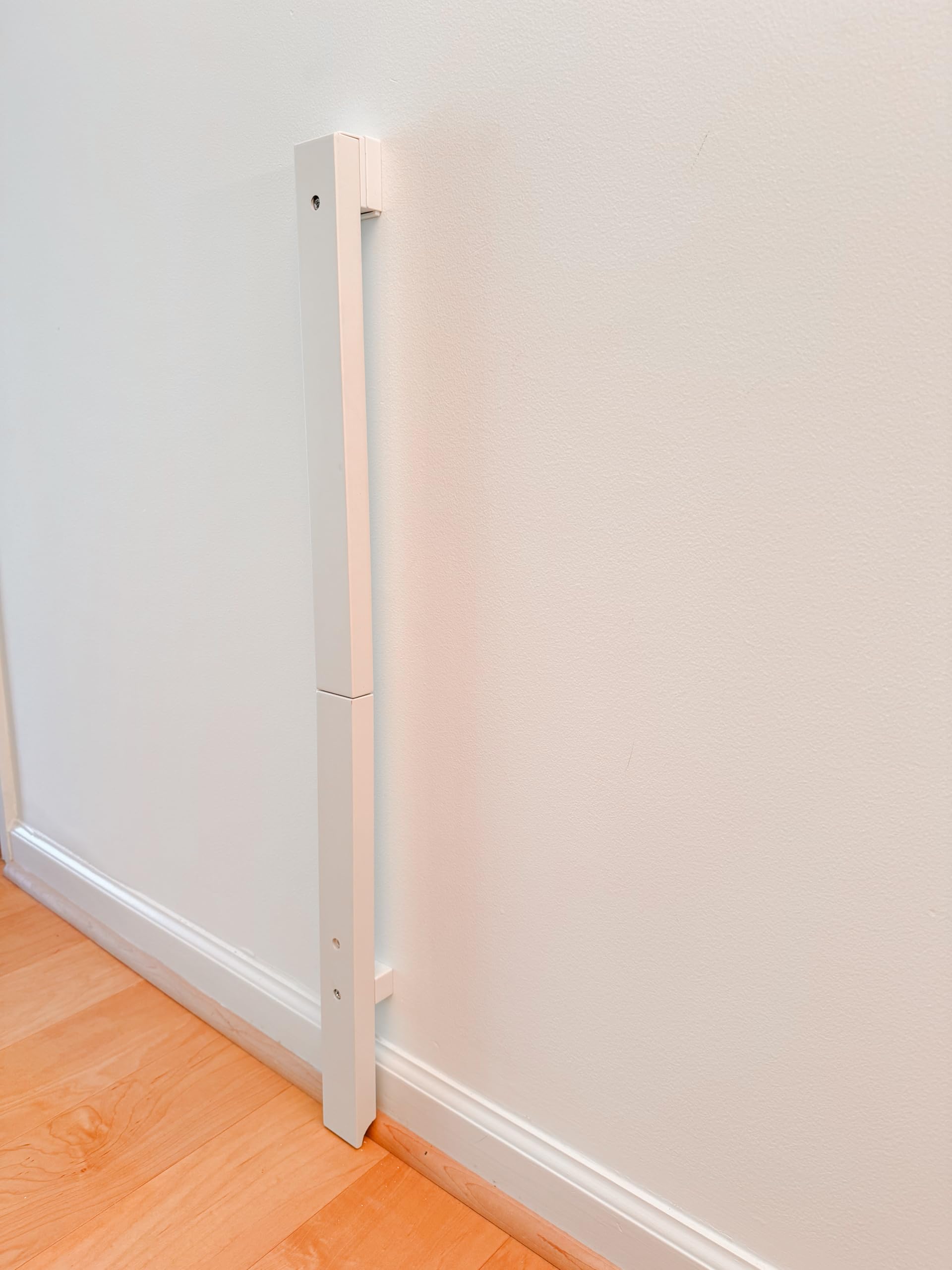 QDOS baseboard adapter (white) installs over baseboards for safe gate mounting and woodwork protection