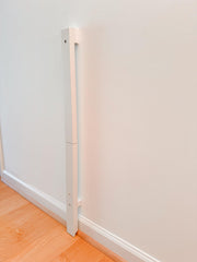 QDOS baseboard adapter (white) installs over baseboards for safe gate mounting and woodwork protection