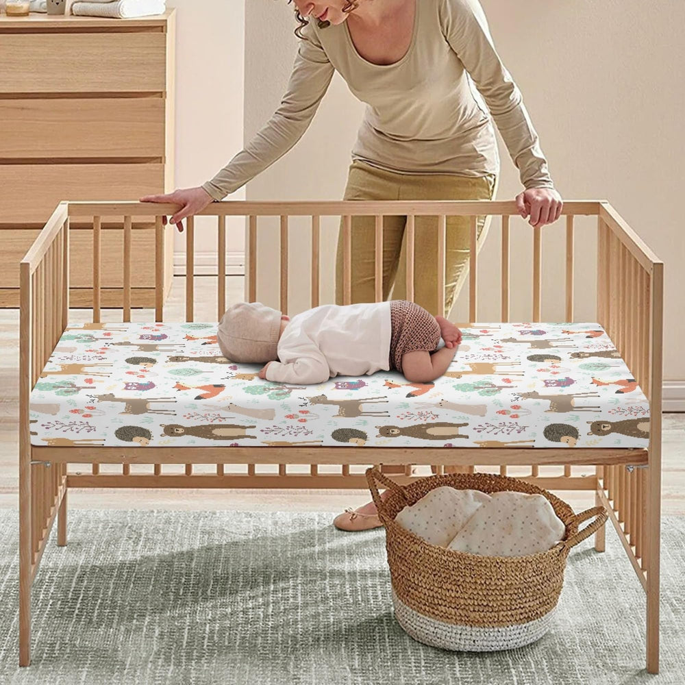QINBEIDU fully elastic crib sheet closeup demonstrates secure, stay-in-place fit for wriggly toddlers.