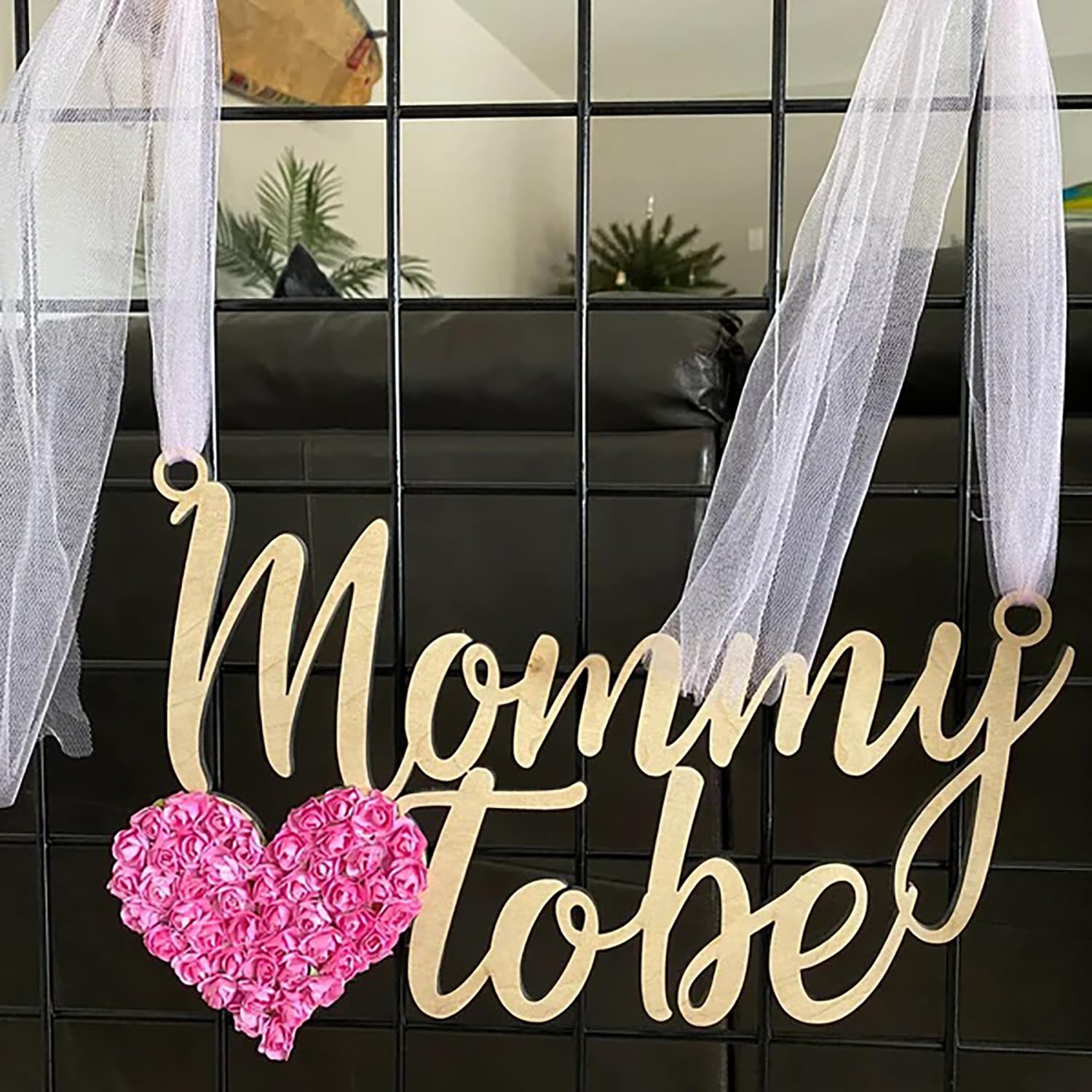 QPARTYFIRE Mommy to Be Chair Sign shown among party decor for memorable moment.
