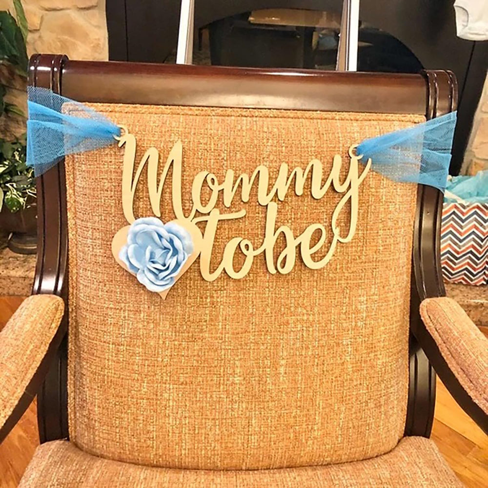 QPARTYFIRE Mommy to Be Chair Sign complements gender reveal and celebration aesthetics.