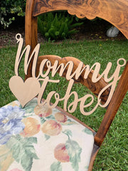 QPARTYFIRE Mommy to Be Chair Sign on chair enhances focal moment of the reveal.