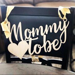 QPARTYFIRE Mommy to Be Chair Sign on wooden base styling the baby shower décor.