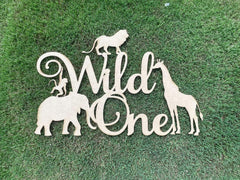 QPARTYFIRE Wild One sign backdrop on wood for safari-themed parties.