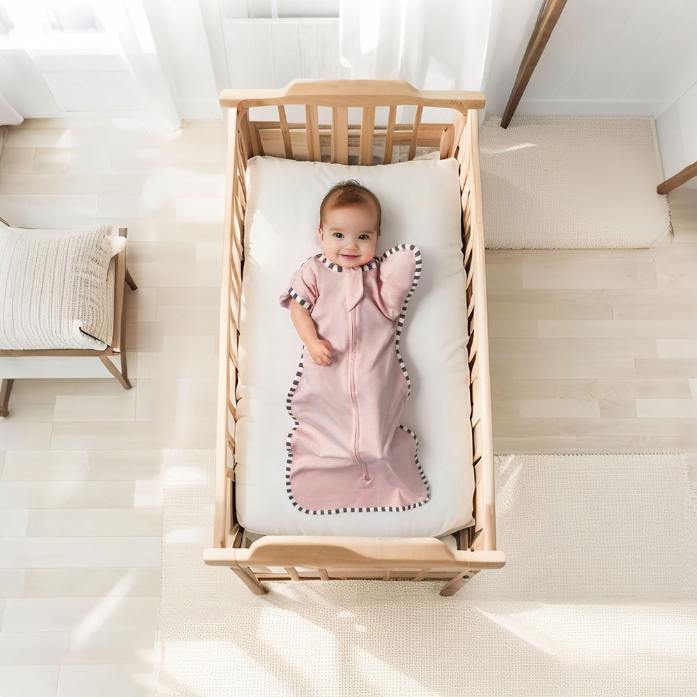 QUENESS arm-up swaddle cuffs show space for little arms during night sleep