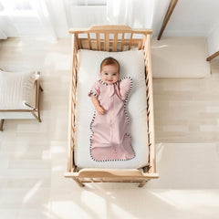 QUENESS arm-up swaddle cuffs show space for little arms during night sleep
