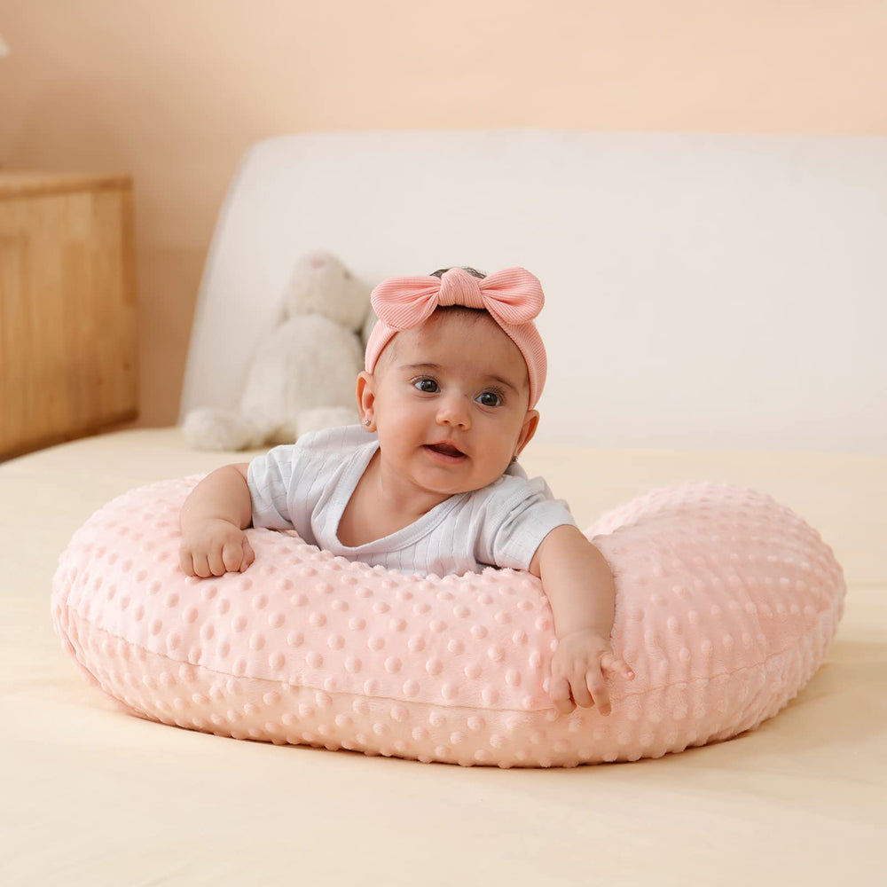 QUENESS nursing pillow during feeds reduces arm fatigue with arm support.