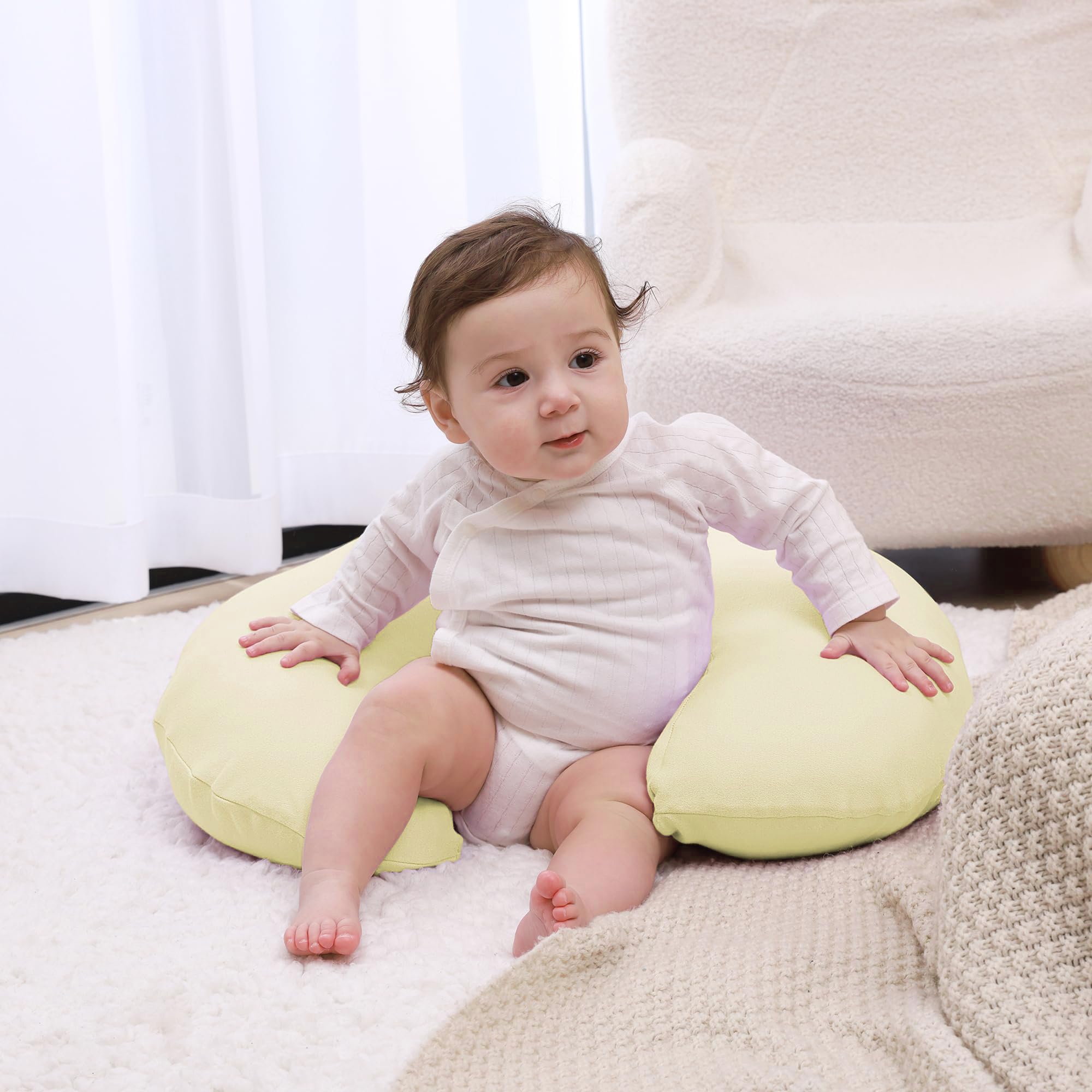 QUENESS Nursing Pillow baby feeding setup provides arm support during feeds.
