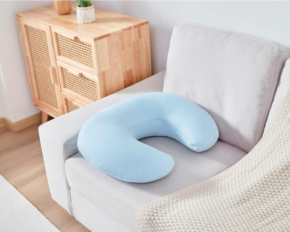 QUENESS nursing pillow in-use during feeding demonstrates ergonomic support.