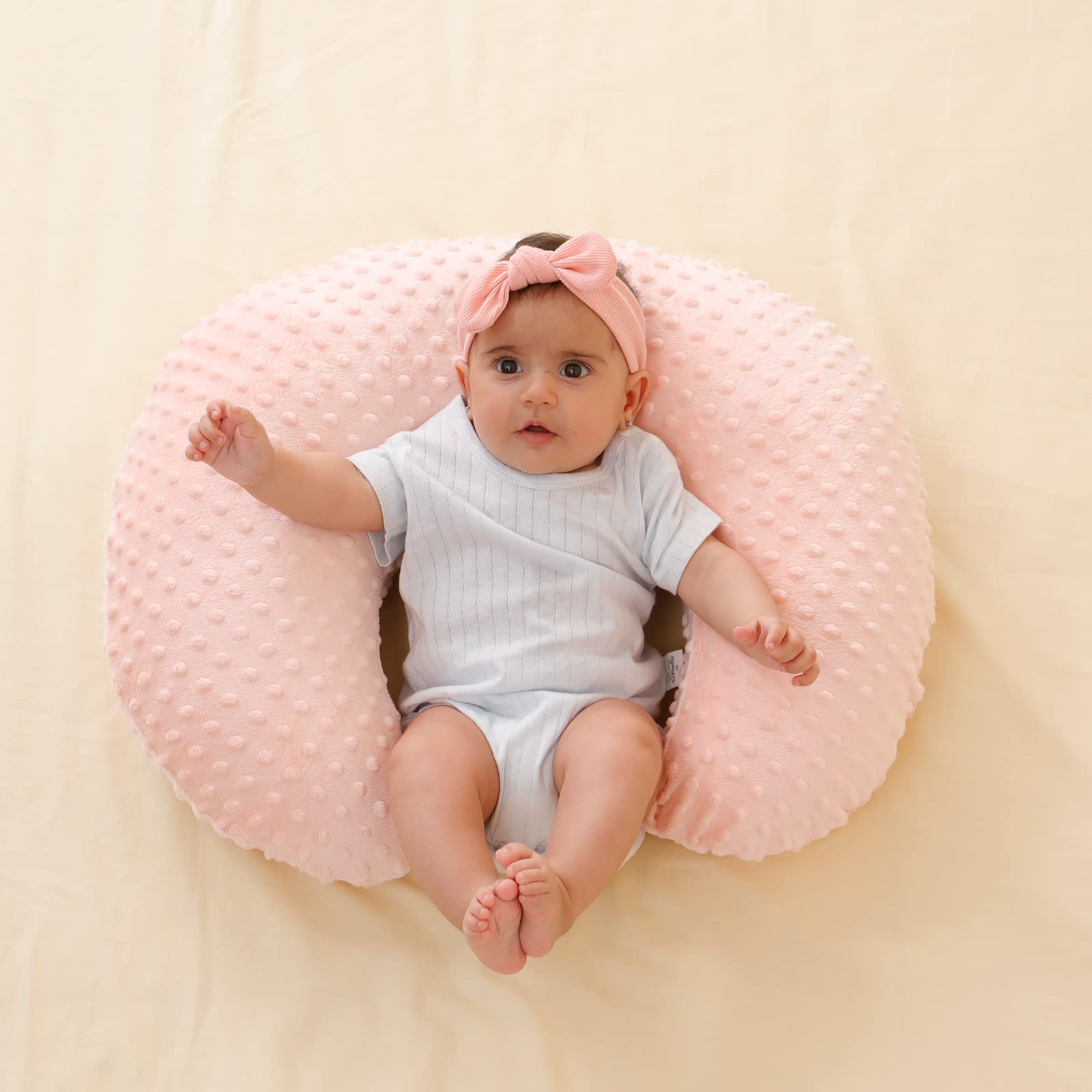 QUENESS nursing pillow lightpink cover closeup shows gentle color and soft fabric.