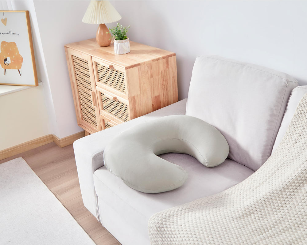 QUENESS pillow used for tummy time and propping as babies grow.