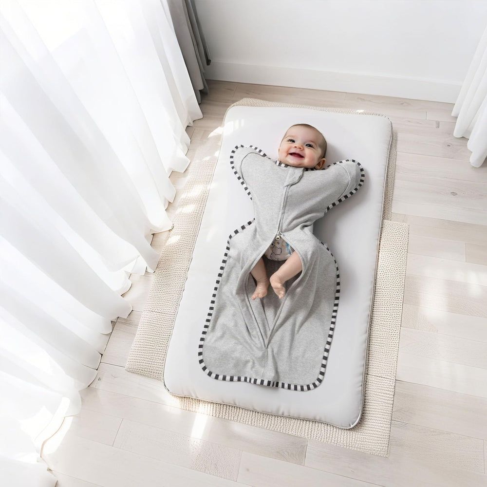 QUENESS baby sleeping scene shows secure wrap helping soothing nighttime sleep