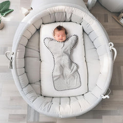 QUENESS Transition Swaddle mitten cuffs demonstrate cozy arm space for gradual arms-free sleep.
