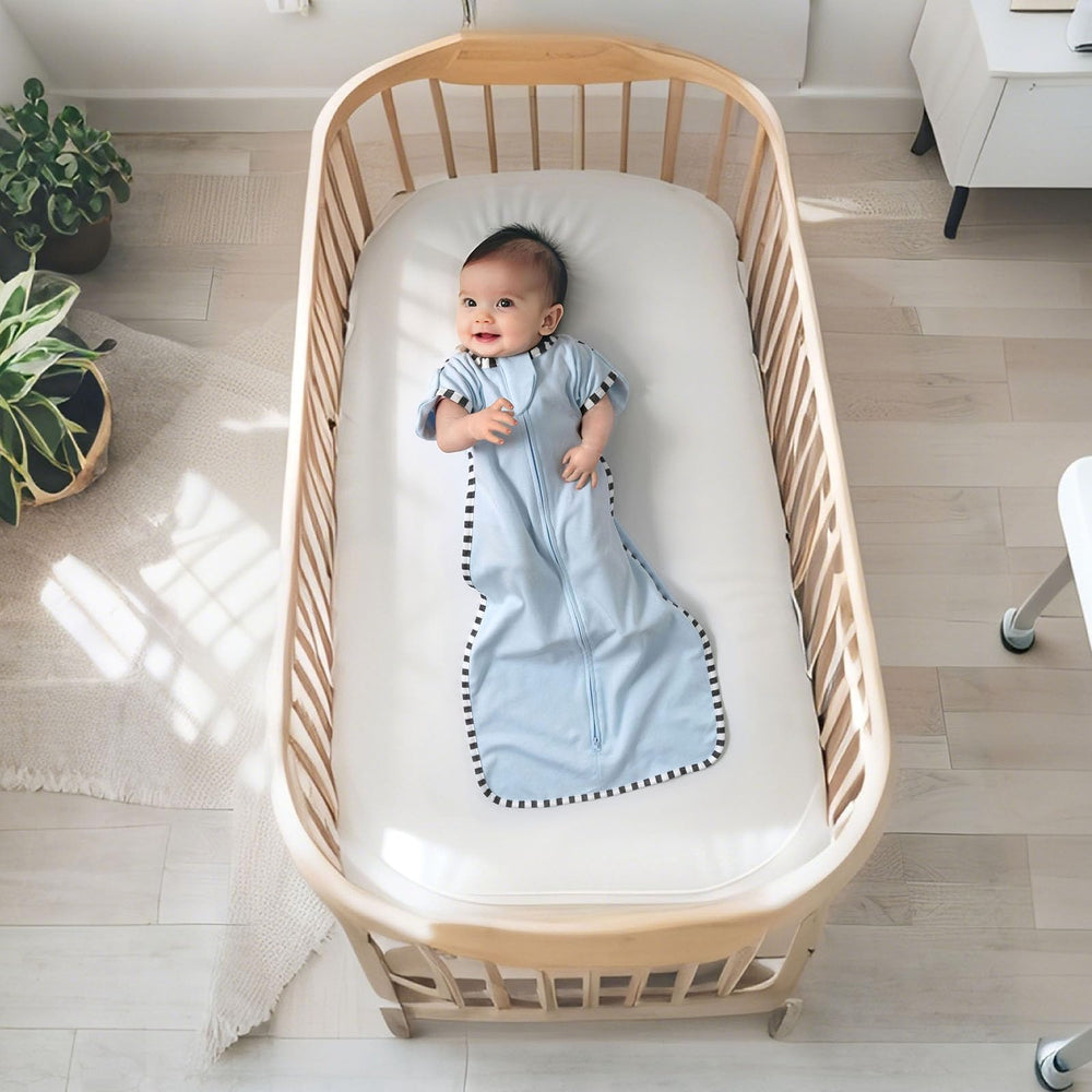 QUENESS transition swaddle soft cotton fabric image emphasizes baby-safe breathability
